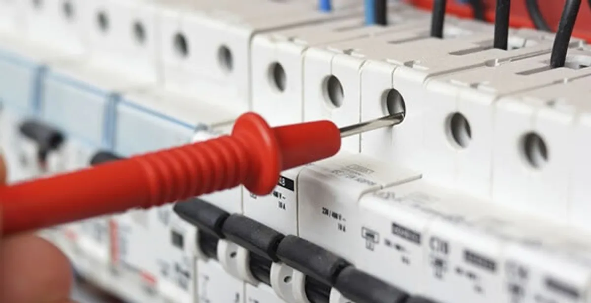 Electrical contractor testing circuit breakers during electrical repair in Beachwood, OH