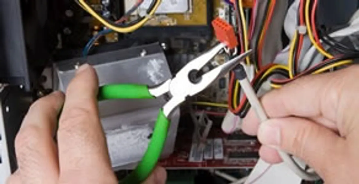 Licensed electrical contractor performing electrical repair with tools in Beachwood, OH
